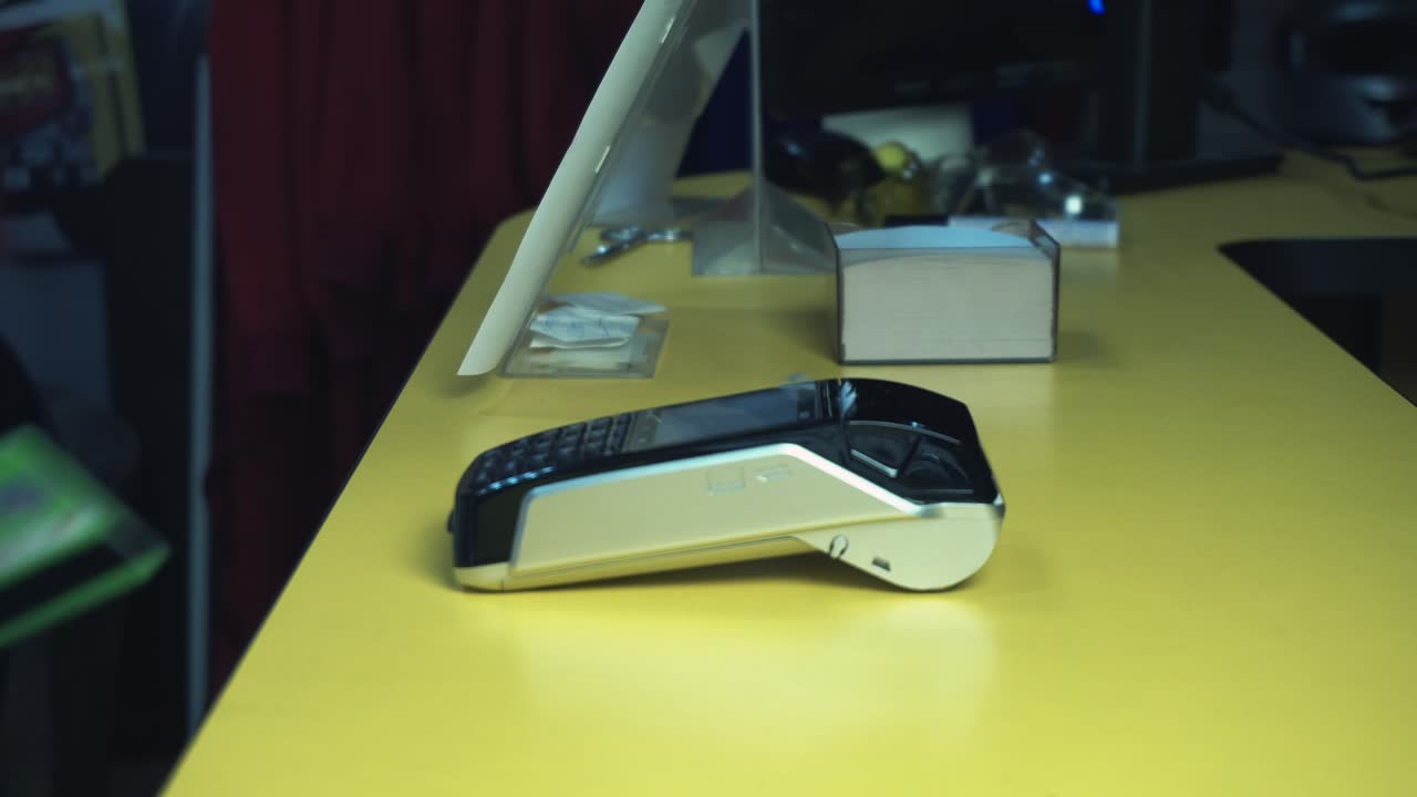 Person using a payment terminal to process a credit card transaction