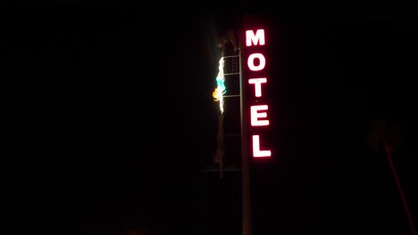 neon motel sign at night with neon diver