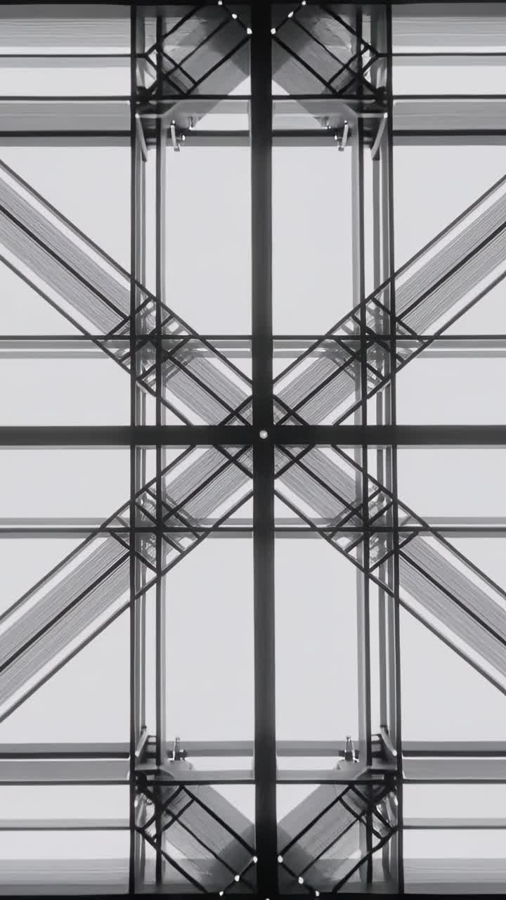 Video verticale: Telecamera che si allontana, rivelando una griglia di tetto vetrato in un atrio e mostrando un nodo centrale.