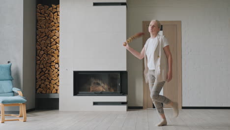 woman dancing/sweeping in a modern living room