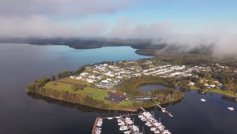 trinity point waterfront homes and marina viewed from above in clear conditions, aerial pullback