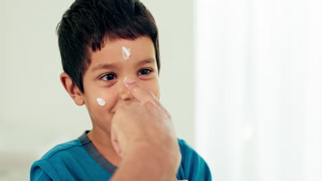 young boy, skincare and lotion with a smile