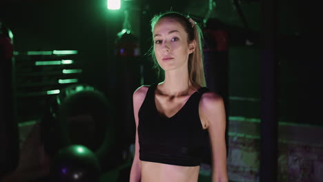 Handheld-Shot-Of-Confident-Sporty-Young-Woman-Standing-In-Gym