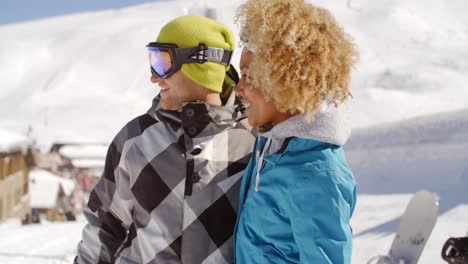 Adult-woman-looking-at-friend-near-snowboards