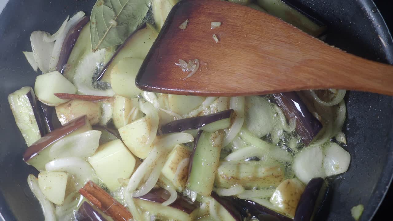 Cooking Eggplant, Onions, and Potatoes