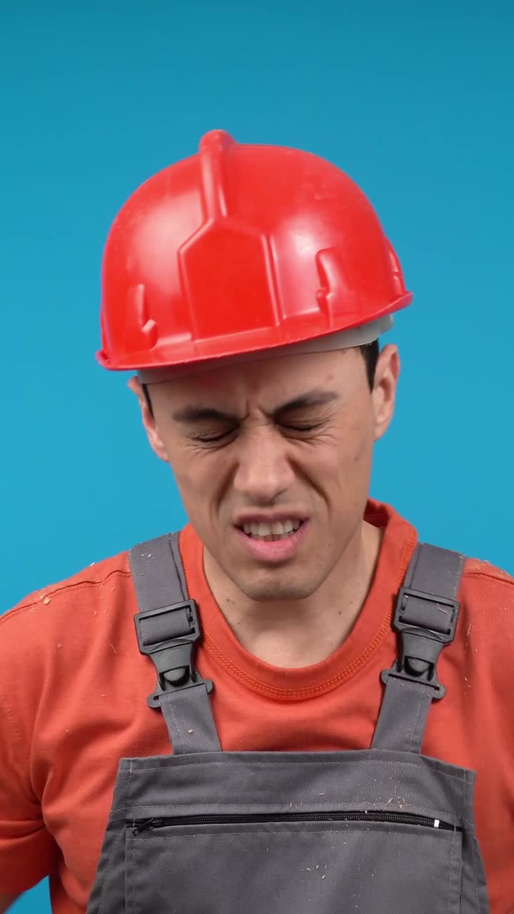 Construction Worker Expressing Pain and Discomfort