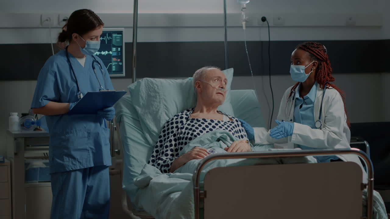 Multi ethnic medical personnel monitoring patient health