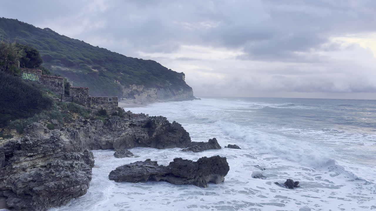 rocky coastline with waves crashing against shore at dusk