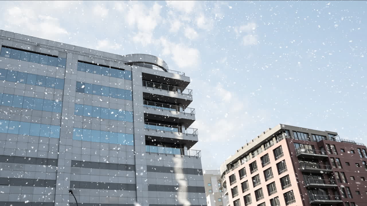 Snowfall animation over modern office buildings against blue sky
