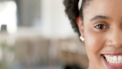 A-close-up-captures-a-cheerful-African-American-woman-with-a-bright-smile,-with-copy-space