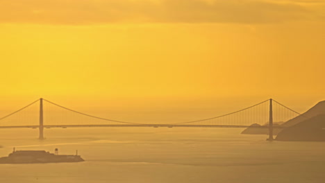 time lapse, yellow evening sunlight above golden gate bridge and pacific ocean, san francisco bay ca usa