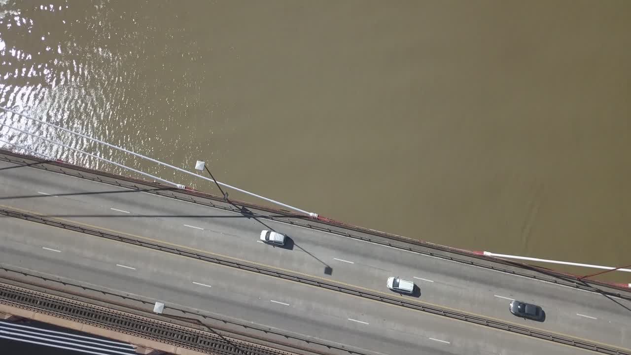 Aerial shot of cars and trucks passing over the bridge