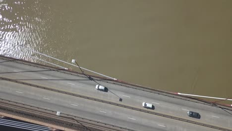 aerial shot of cars and trucks passing over the bridge