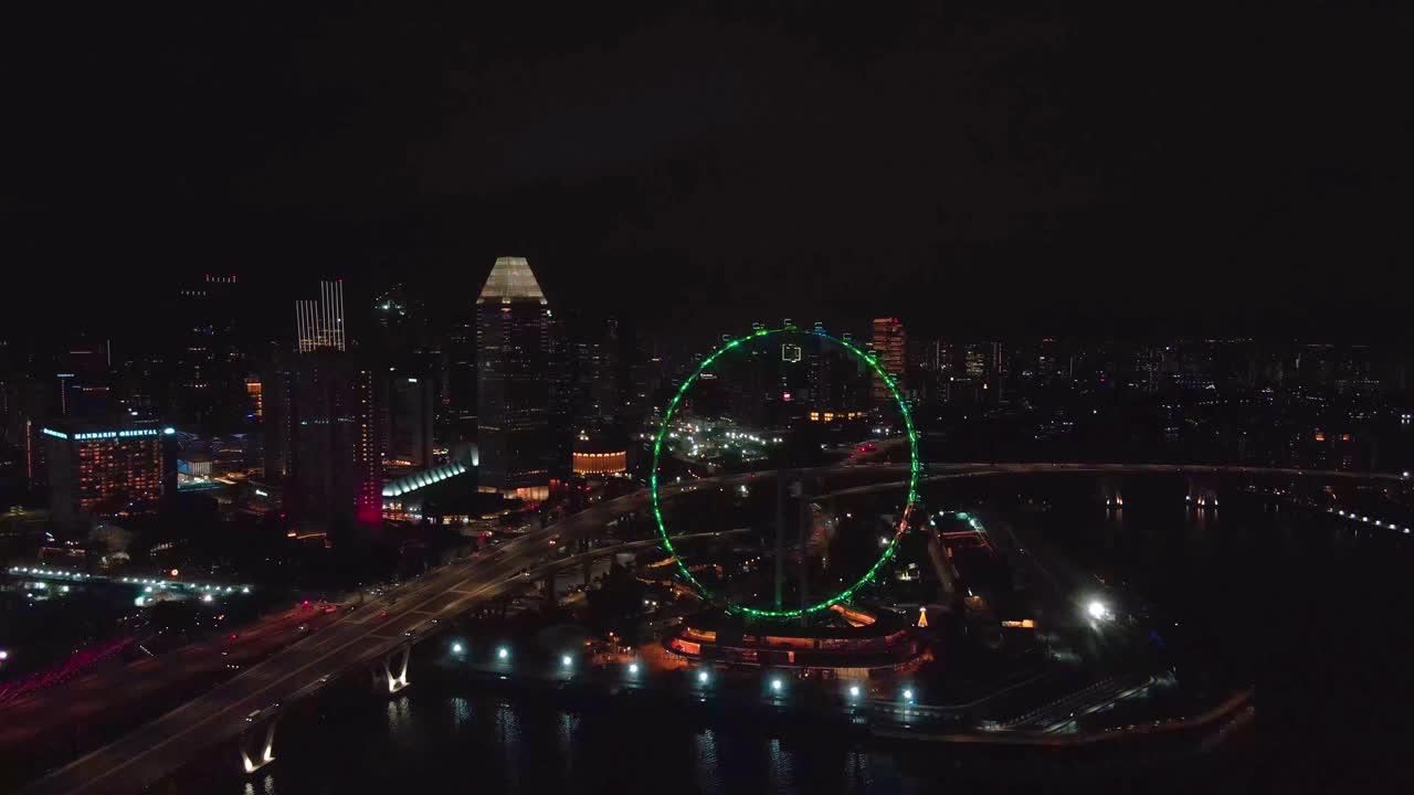 Singapore skyline glittering over Marina Bay at night