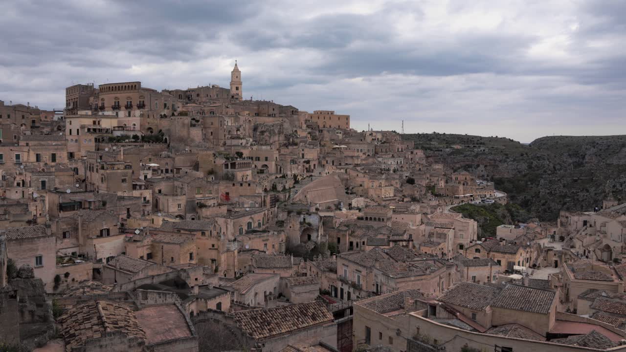 Steady camera showing a panoramic view over Matera, Italy's UNESCO heritage with medieval architecture and historical viewpoint