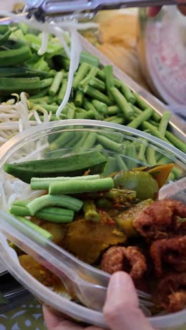 assembling ingredients for traditional thai soup.