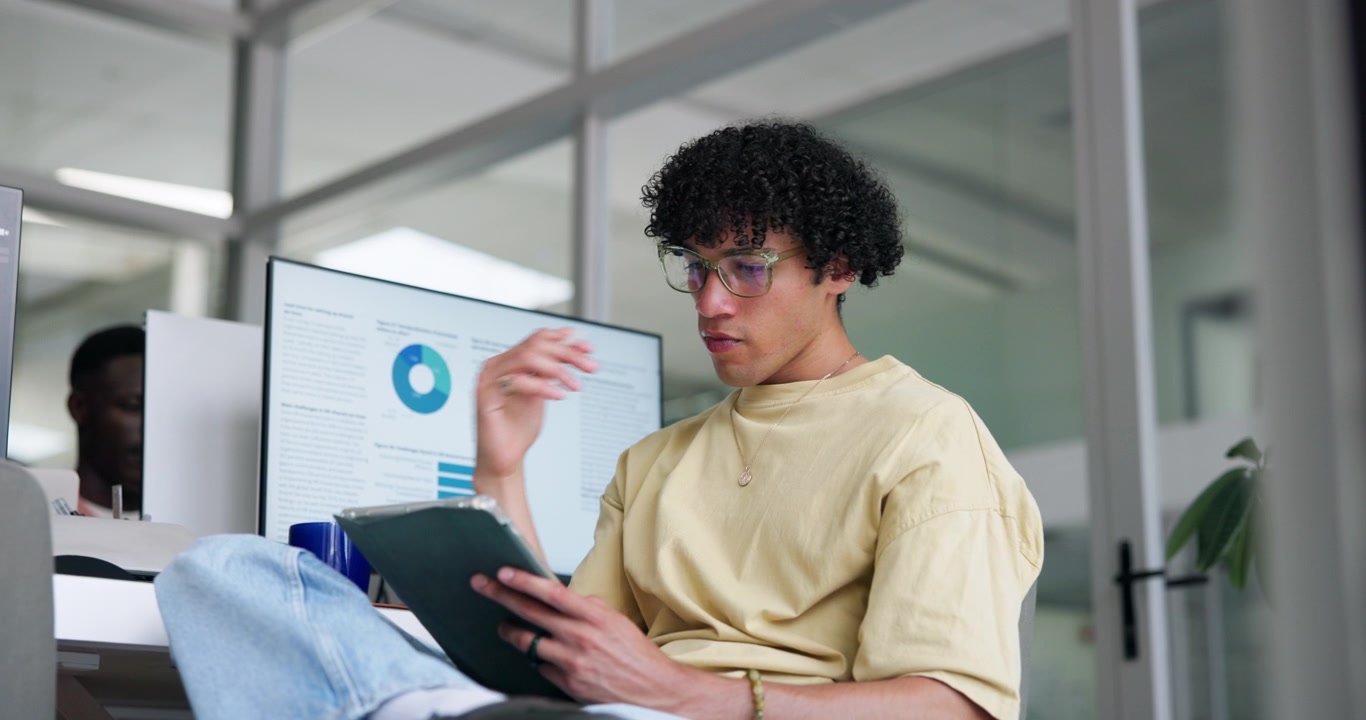 Young Man Using Tablet in Modern Office Workspace