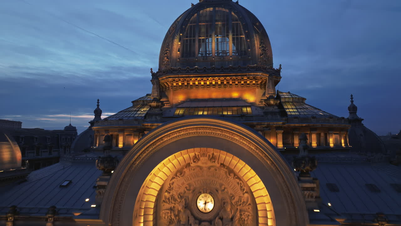 Aerial drone view of the illuminated Palace of the Deposits and Consignments in the evening. Blue hour in Bucharest, Romania