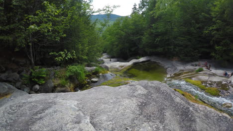 4k-stationary-shot-Maine-forest-wilderness-Stepp-Falls-Hiking-trail-area-filled-with-cascades-and-waterfalls-with-large-crystal-clear-pools-of-water-for-swimming