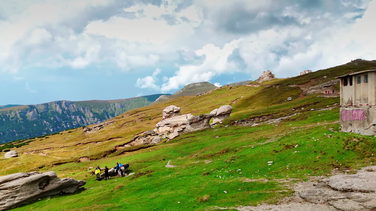Scenic views of Busteni mountains in Romania during travel. Explore the picturesque landscape of Busteni, Romania, showcasing serene mountains and rocky terrain under a cloudy sky