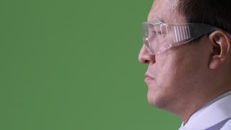 mature japanese man doctor wearing protective glasses