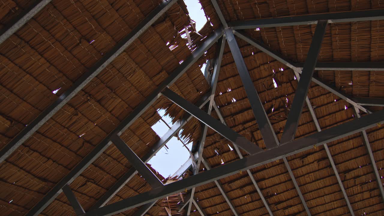 Damaged Straw Roof with Metal Frame