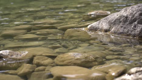 clear river flow between the rocks, very fresh and clean