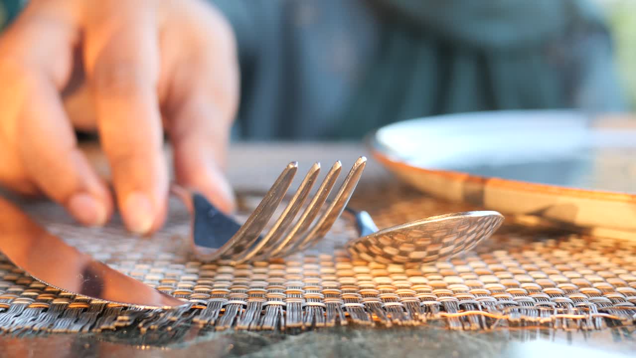 Close-up of a fork, spoon, and knife on a table setting