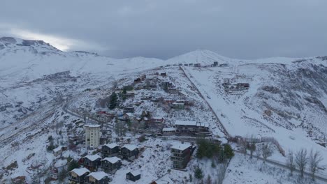 Aerial-establishing-shot-of-the-small-village-Farellones-in-the-Andean-Mountain-Range