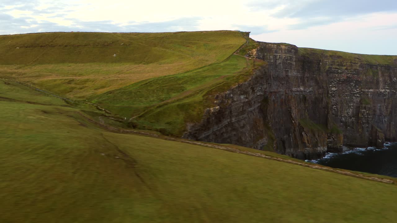 Panoramic views of the majestic Cliffs of Moher in Ireland, showcasing the rugged coastline and the Atlantic Ocean