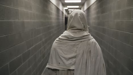 Jesus-Wearing-White-Robe-Walks-In-Prison-Hallway-In-Slow-Motion