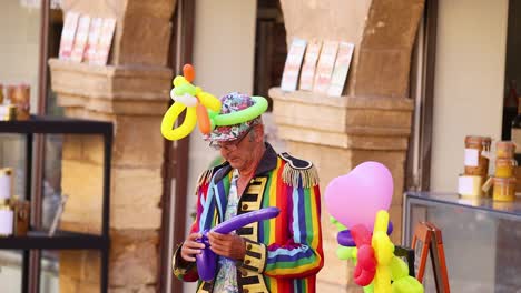 colorful performer creating balloon animals in caneda, france