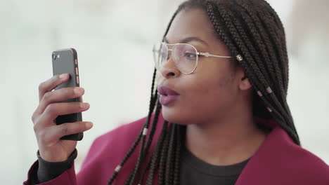 Afro-American-attractive-young--girl-with-plump-rose-lips-and-braids-in-aviator-eyeglasses-wearing-rose-coat