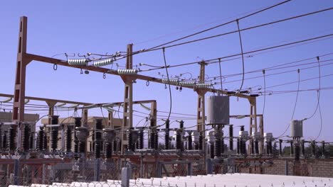 high voltage substation from above: wide angle view of tall pylons and extensive distribution cables