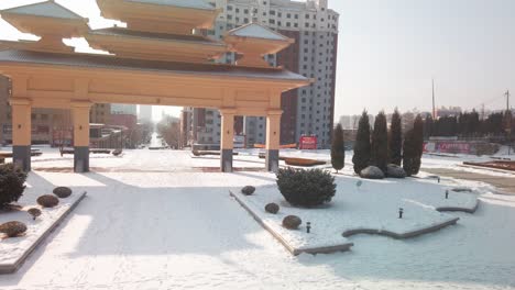 Panning-shot-of-a-Chinese-gate-in-a-small-industrial-Chinese-town-during-the-winter