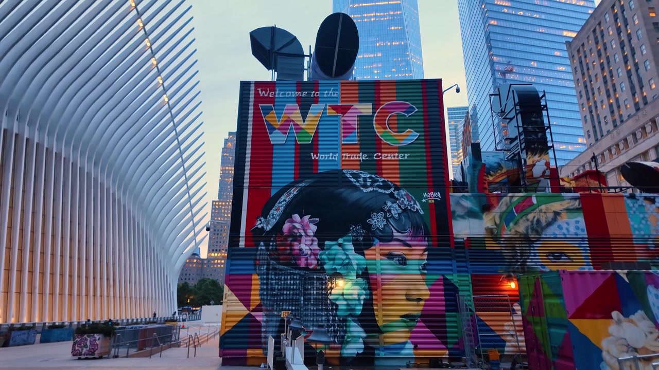New York, USA, 5 June 2026 : Painted building beside Oculus transit hub, New York City. Colorful portrait mural, rooftop vents and glass towers frame the World Trade Center plaza.
