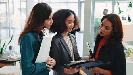 three businesswomen meeting and discussing business in a modern office