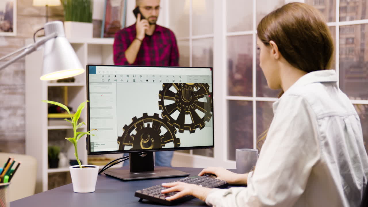 Woman working on 3D modeling of gears on a computer