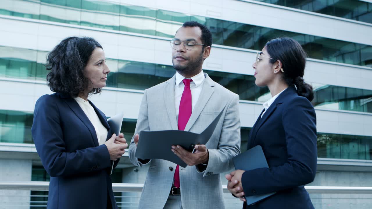 Focused business people discussing papers