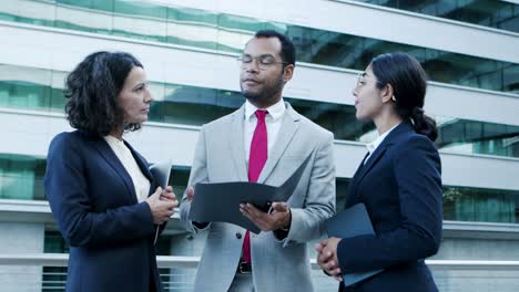 focused business people discussing papers