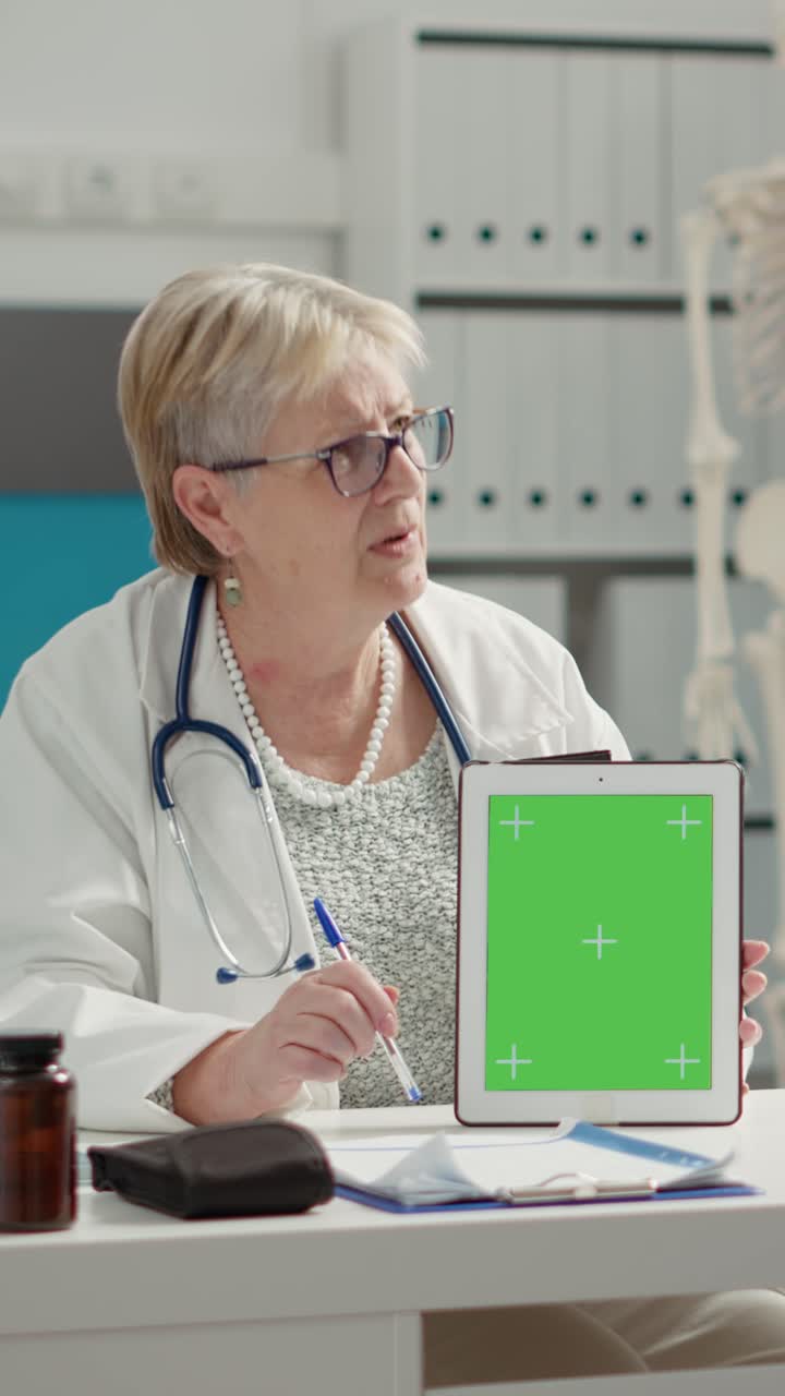 Doctor holding tablet with green screen