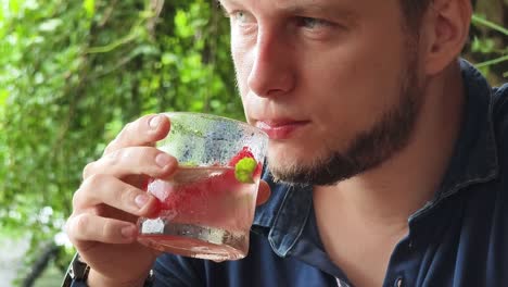 man drinking watermelon cocktail