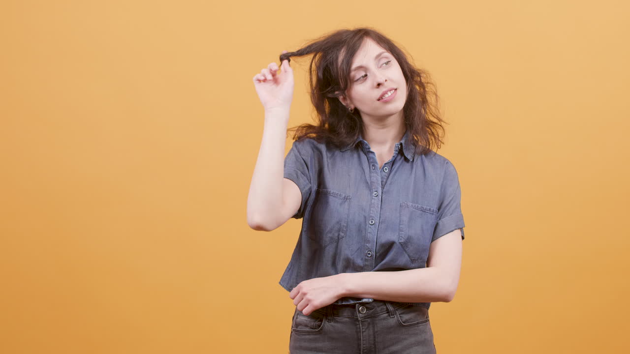 Woman in denim shirt posing in studio