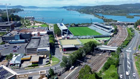 Drone-aerial-Gosford-city-waterfront-foreshore-stadium-buildings-railway-train-line-station-travel-tourism-Central-Coast-NSW-Australia-4K