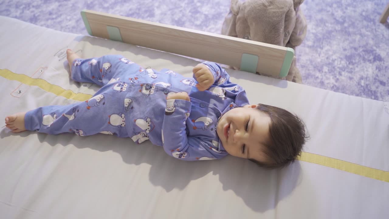The baby who plays with his hand laughs.
