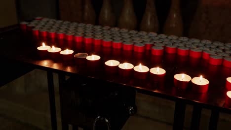 Round-Tealight-Candles-Burning-On-The-Table