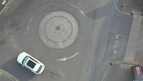aerial shot of white suv driving on round about