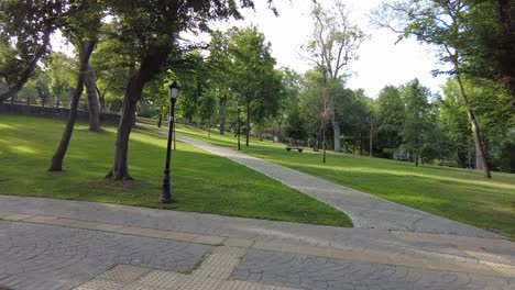 a path through a beautiful park with green grass and trees