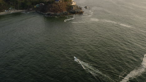 Overflying-a-boat-on-the-coast-of-San-Francisco,-Mexico,-at-sunset