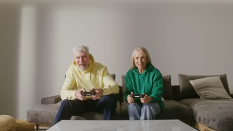 una pareja de mayores feliz jugando videojuegos.